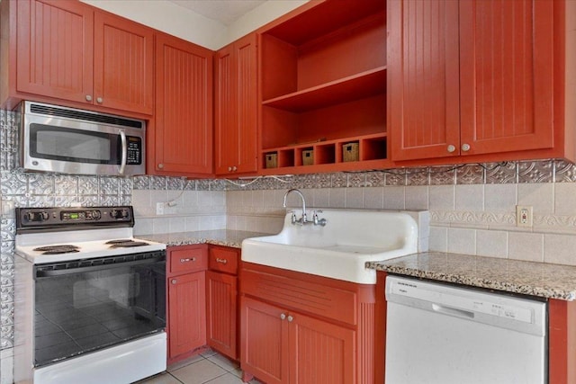 710 Gresham St, Smithville, TX 78957 - kitchen featuring white appliances, open shelves, backsplash, and light stone counters