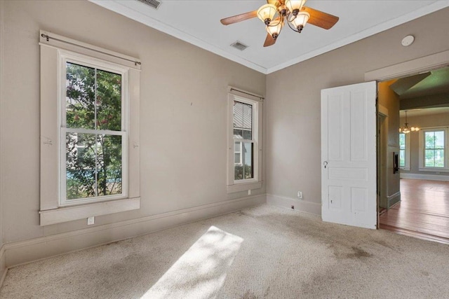 710 Gresham St, Smithville, TX 78957 - unfurnished room featuring carpet floors, crown molding, a chandelier, a smoke detector, and ceiling fan