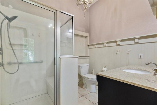710 Gresham St, Smithville, TX 78957 - full bathroom featuring tile patterned floors, an enclosed shower, vanity, and a wainscoted wall