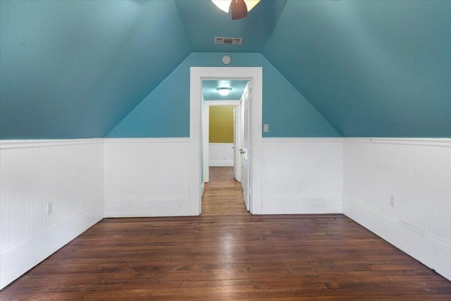 710 Gresham St, Smithville, TX 78957 - additional living space featuring wainscoting, vaulted ceiling, wood finished floors, and a ceiling fan
