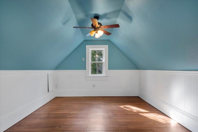 710 Gresham St, Smithville, TX 78957 - bonus room with wainscoting, a ceiling fan, hardwood / wood-style floors, and vaulted ceiling