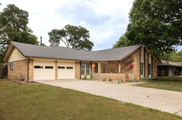 2306 Monarch Dr, Austin, TX 78748 - view of front of house with brick siding, an attached garage, concrete driveway, and a front lawn