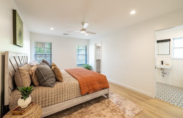 2306 Monarch Dr, Austin, TX 78748 - bedroom with multiple windows, light wood-style flooring, recessed lighting, connected bathroom, and ceiling fan
