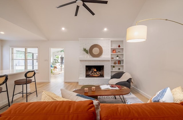 2306 Monarch Dr, Austin, TX 78748 - living room featuring lofted ceiling, a ceiling fan, light wood-style flooring, a brick fireplace, and recessed lighting