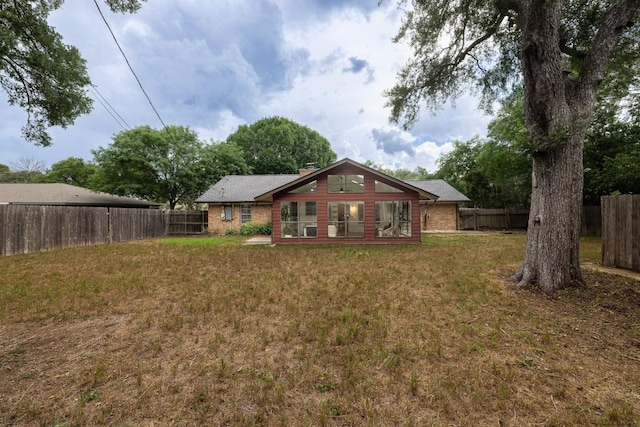 2306 Monarch Dr, Austin, TX 78748 - back of property featuring a fenced backyard, brick siding, and a chimney