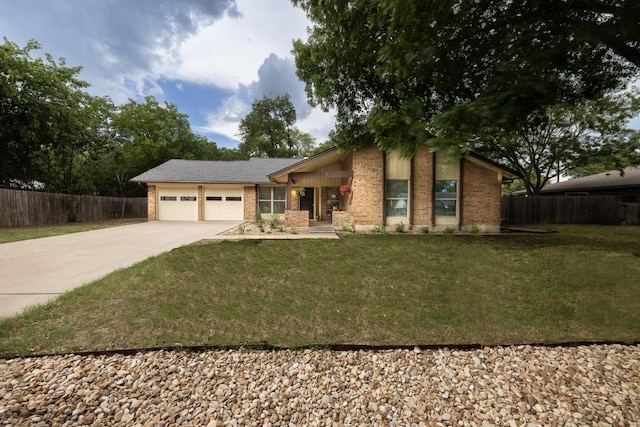 2306 Monarch Dr, Austin, TX 78748 - mid-century home featuring driveway, brick siding, and an attached garage
