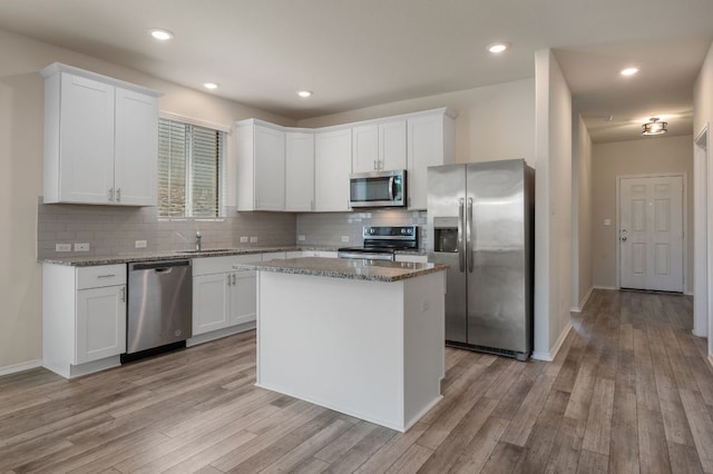 241 Pivot Dr, Taylor, TX 76574 - kitchen with appliances with stainless steel finishes, tasteful backsplash, white cabinets, and recessed lighting