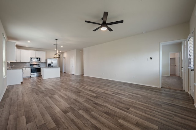 241 Pivot Dr, Taylor, TX 76574 - unfurnished living room with ceiling fan, dark wood-style floors, and recessed lighting
