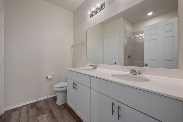 241 Pivot Dr, Taylor, TX 76574 - bathroom featuring double vanity, a stall shower, wood finished floors, and recessed lighting