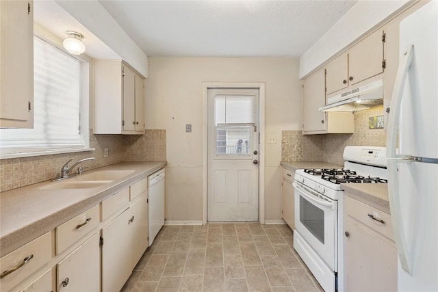 5708 Garden Oaks Dr, Austin, TX 78745 - kitchen with white appliances, under cabinet range hood, light countertops, and backsplash