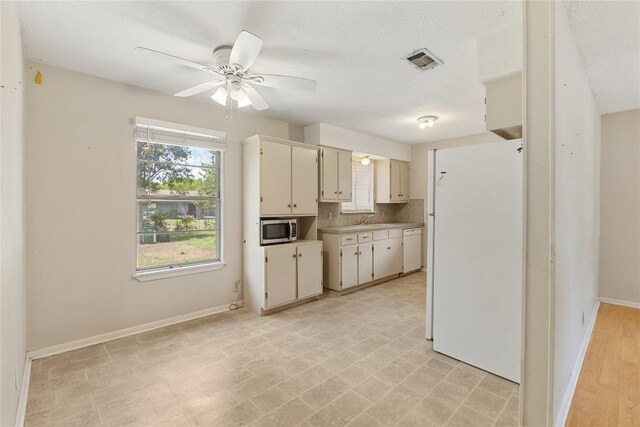 5708 Garden Oaks Dr, Austin, TX 78745 - kitchen featuring white appliances, light countertops, and a ceiling fan