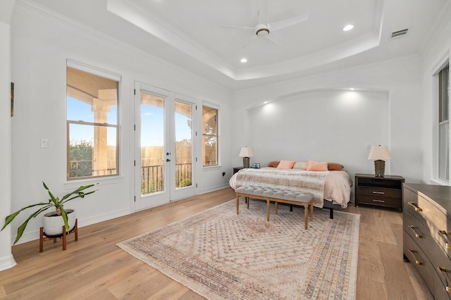 1006 Foothills Dr, Dripping Springs, TX 78620 - bedroom with french doors, access to exterior, a tray ceiling, light wood-style floors, and ornamental molding
