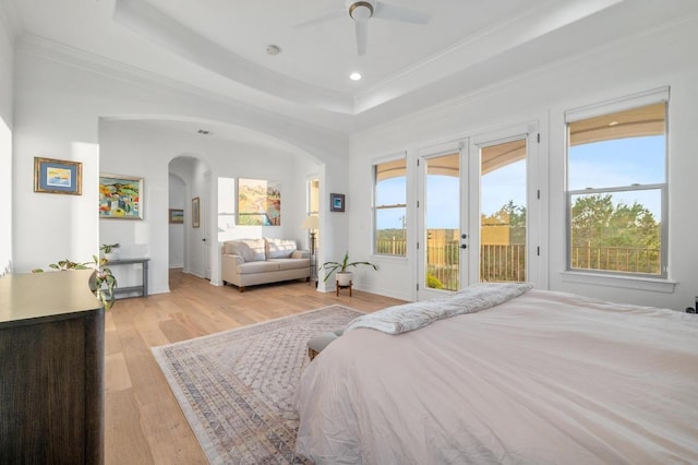 1006 Foothills Dr, Dripping Springs, TX 78620 - bedroom with access to exterior, arched walkways, a raised ceiling, light wood-style floors, and crown molding