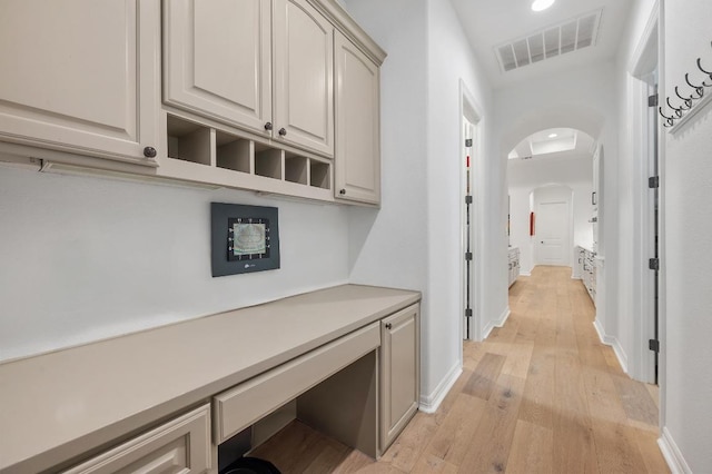 1006 Foothills Dr, Dripping Springs, TX 78620 - hallway featuring arched walkways, light wood finished floors, and recessed lighting