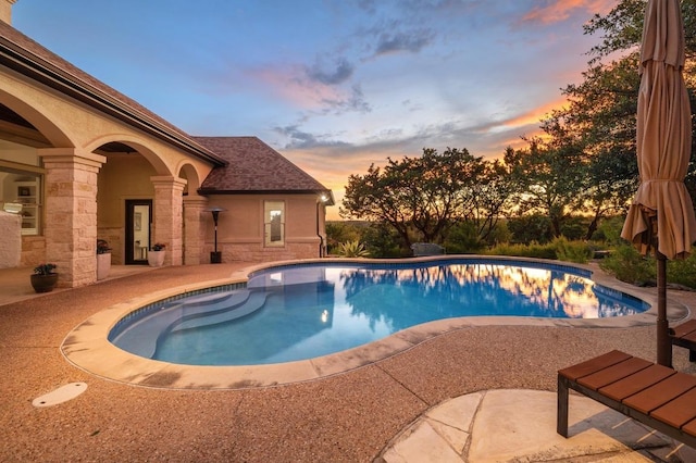 1006 Foothills Dr, Dripping Springs, TX 78620 - pool at dusk featuring an outdoor pool and a patio