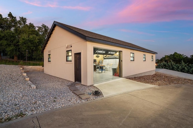 1006 Foothills Dr, Dripping Springs, TX 78620 - view of side of property featuring stucco siding and a patio area