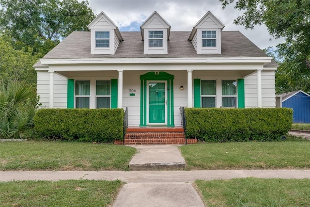 1106 S 11th St, Temple, TX 76504 - cape cod-style house with covered porch, a front yard, and a shingled roof