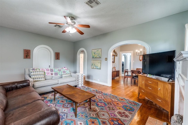 1106 S 11th St, Temple, TX 76504 - living area featuring arched walkways, ceiling fan, and wood finished floors