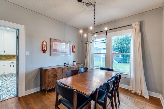 1106 S 11th St, Temple, TX 76504 - dining room featuring wood finished floors and a chandelier