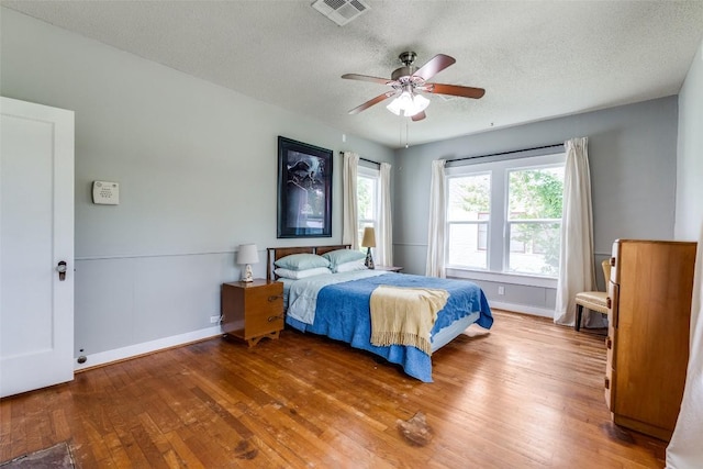1106 S 11th St, Temple, TX 76504 - bedroom with wood finished floors, a textured ceiling, and ceiling fan
