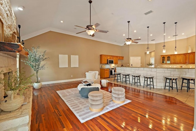 1806 Carey Ave, Taylor, TX 76574 - living area with ceiling fan, hardwood / wood-style flooring, ornamental molding, lofted ceiling, and recessed lighting
