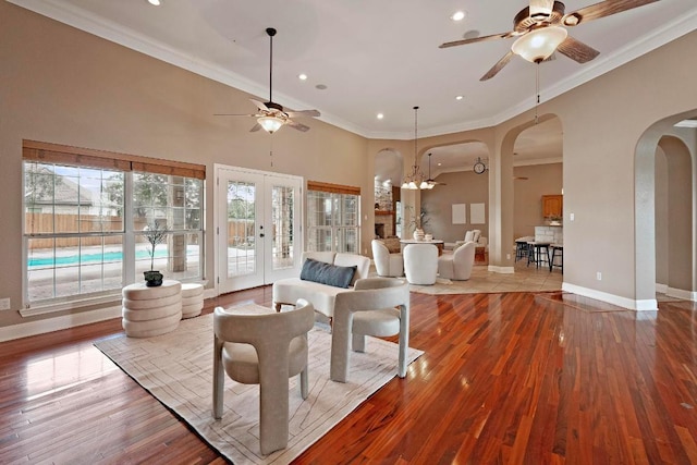1806 Carey Ave, Taylor, TX 76574 - living area with a ceiling fan, arched walkways, french doors, ornamental molding, and wood finished floors
