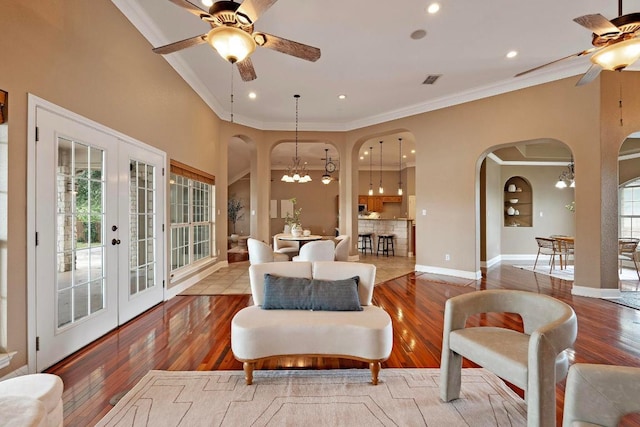 1806 Carey Ave, Taylor, TX 76574 - living area featuring a ceiling fan, arched walkways, crown molding, french doors, and hardwood / wood-style flooring