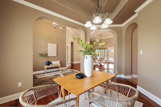 1806 Carey Ave, Taylor, TX 76574 - dining space featuring a chandelier, arched walkways, and ornamental molding