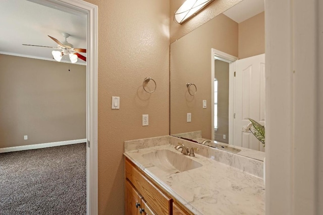 1806 Carey Ave, Taylor, TX 76574 - bathroom featuring vanity, a ceiling fan, and a textured wall
