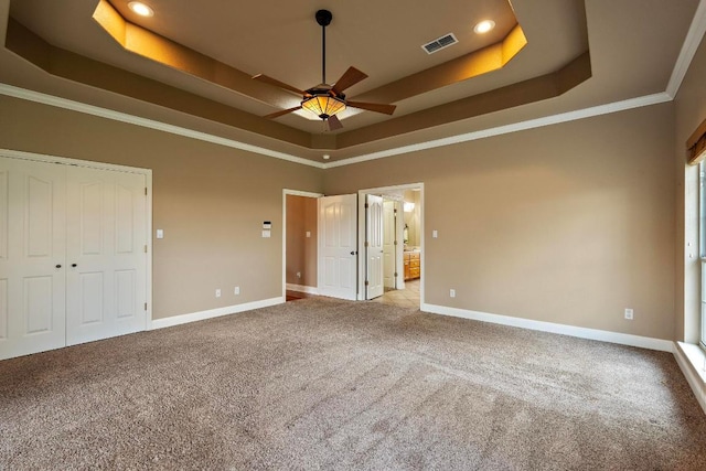 1806 Carey Ave, Taylor, TX 76574 - unfurnished bedroom with a tray ceiling, carpet floors, ornamental molding, recessed lighting, and ensuite bathroom