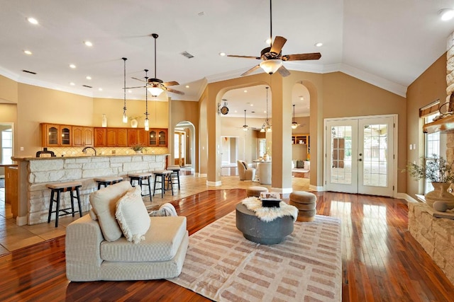 1806 Carey Ave, Taylor, TX 76574 - living room with ceiling fan, arched walkways, plenty of natural light, hardwood / wood-style flooring, and crown molding