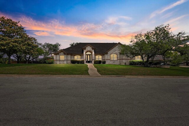 1806 Carey Ave, Taylor, TX 76574 - french provincial home with stone siding and a yard