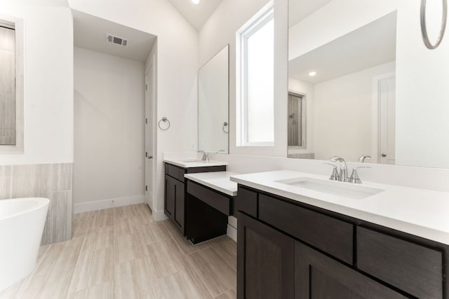 2935 Mckinnie Park, Bulverde, TX 78163 - bathroom featuring a freestanding tub, vanity, and recessed lighting