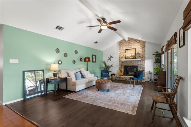 225 Spanish Oak Dr, Georgetown, TX 78628 - living room featuring beamed ceiling, plenty of natural light, ceiling fan, a brick fireplace, and wood finished floors