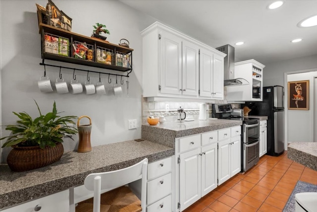 225 Spanish Oak Dr, Georgetown, TX 78628 - kitchen featuring range with two ovens, open shelves, wall chimney exhaust hood, white cabinets, and freestanding refrigerator