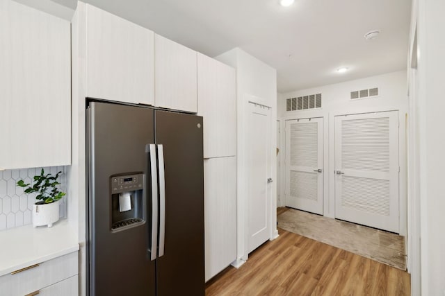 4802 S Congress Ave Unit 215, Austin, TX 78745 - kitchen featuring stainless steel fridge with ice dispenser, light wood-style flooring, decorative backsplash, light countertops, and recessed lighting