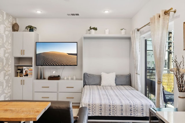 4802 S Congress Ave Unit 215, Austin, TX 78745 - bedroom with wallpapered walls and access to exterior