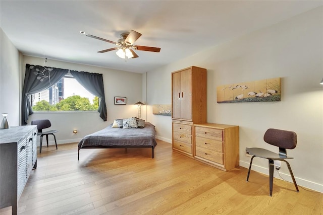 40 N Interstate 35 Hwy Unit 5B2, Austin, TX 78701 - bedroom featuring light wood-style flooring and ceiling fan