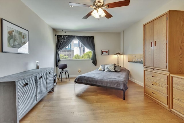 40 N Interstate 35 Hwy Unit 5B2, Austin, TX 78701 - bedroom featuring light wood-style floors and a ceiling fan