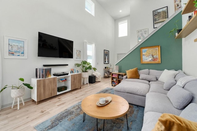 7713 Saddle Up Dr, Austin, TX 78724 - living area with light wood-style flooring, a towering ceiling, and recessed lighting