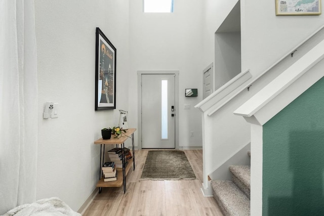 7713 Saddle Up Dr, Austin, TX 78724 - entryway featuring stairway, wood finished floors, and a towering ceiling