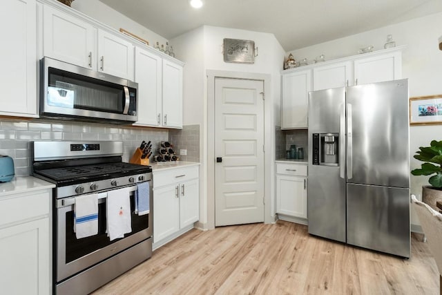 7713 Saddle Up Dr, Austin, TX 78724 - kitchen featuring appliances with stainless steel finishes, light countertops, white cabinetry, light wood-style flooring, and recessed lighting