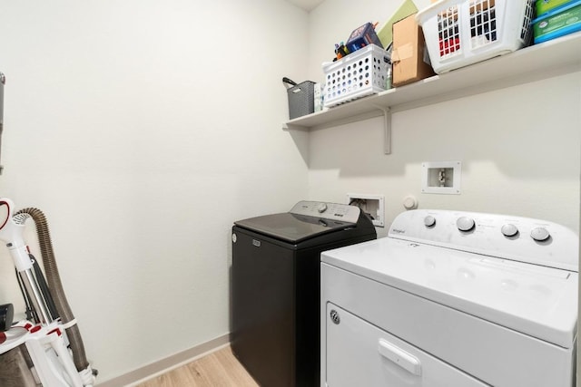 7713 Saddle Up Dr, Austin, TX 78724 - laundry area featuring washer and dryer and light wood-style floors
