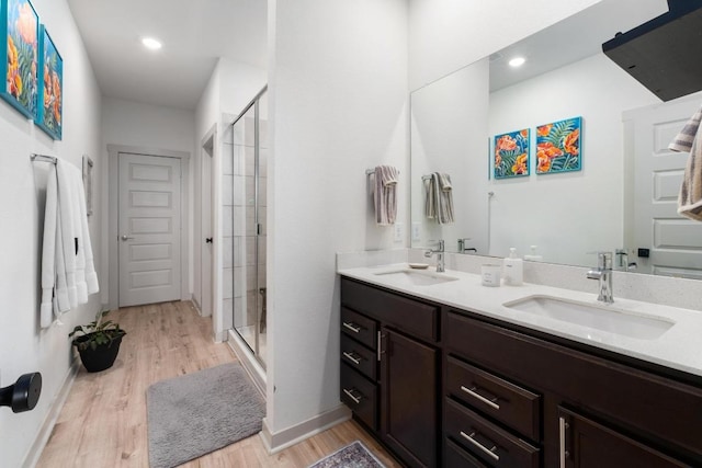 7713 Saddle Up Dr, Austin, TX 78724 - full bathroom with double vanity, a stall shower, and wood finished floors