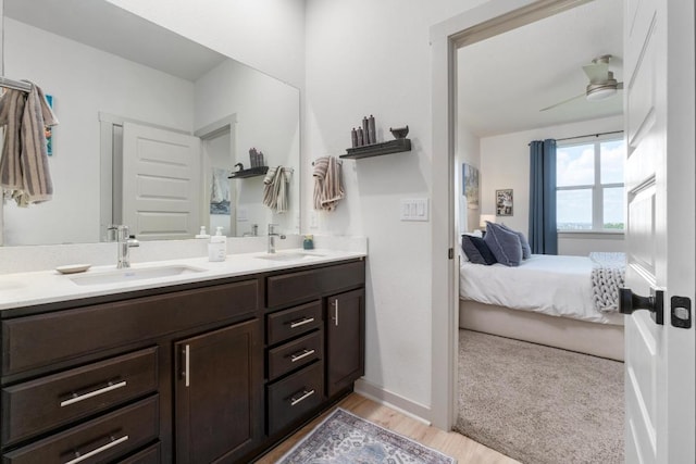 7713 Saddle Up Dr, Austin, TX 78724 - ensuite bathroom with double vanity and wood finished floors