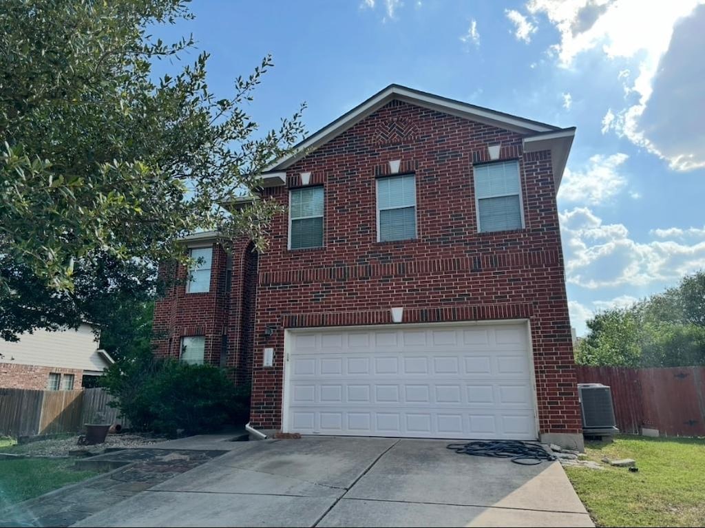 21008 Hallbrook Ln, Pflugerville, TX 78660 - traditional-style house featuring brick siding, concrete driveway, and a garage