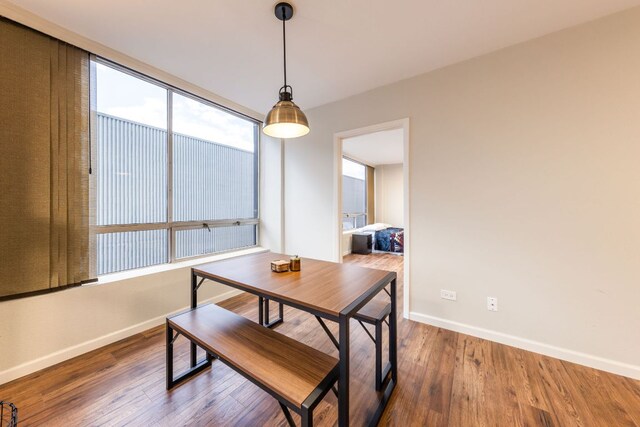 1212 Guadalupe St Unit 301, Austin, TX 78701 - dining room featuring baseboards and wood finished floors