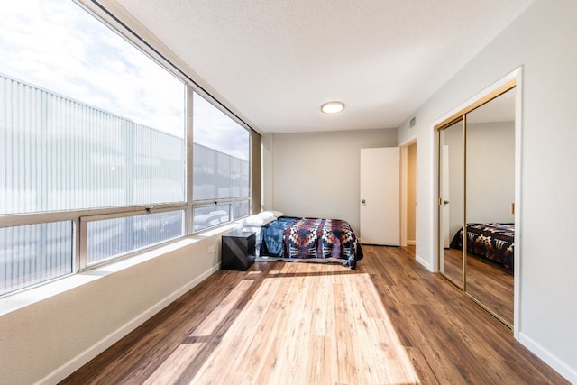 1212 Guadalupe St Unit 301, Austin, TX 78701 - bedroom with wood finished floors and a closet