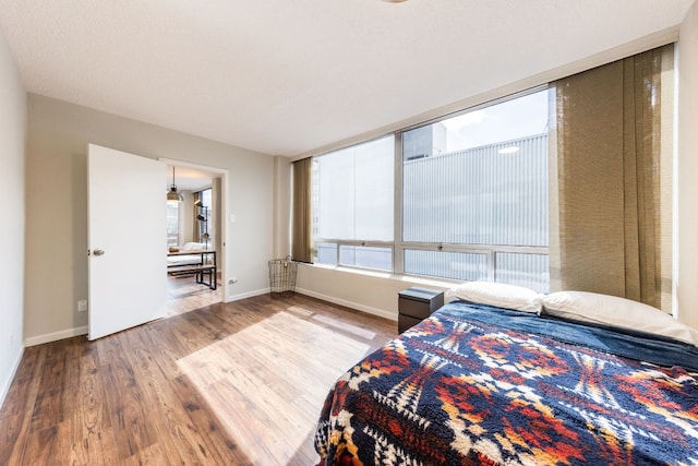 1212 Guadalupe St Unit 301, Austin, TX 78701 - bedroom with multiple windows and wood finished floors