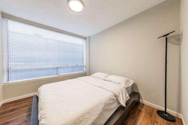 1212 Guadalupe St Unit 301, Austin, TX 78701 - bedroom featuring multiple windows and dark wood-style flooring